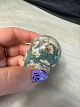 Load image into Gallery viewer, Rhyolite flower in African green jasper Skull
