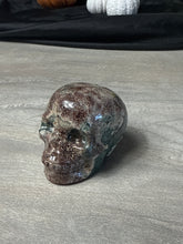 Load image into Gallery viewer, Rhyolite flower in African green jasper Skull
