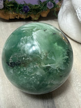 Load image into Gallery viewer, Feather Snowflake Fluorite Sphere
